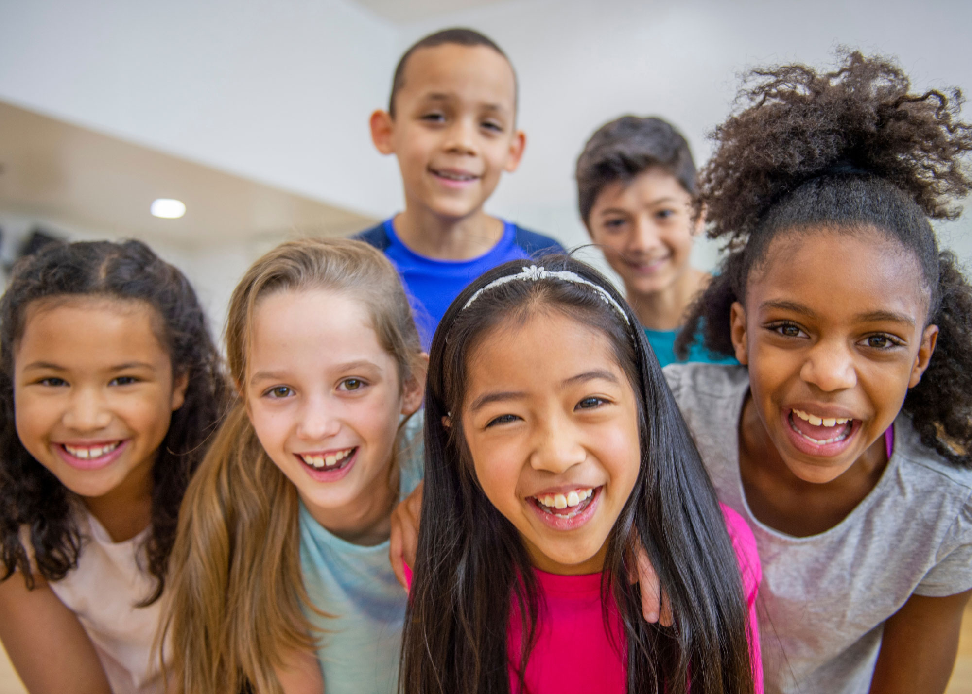 six kids smiling in class